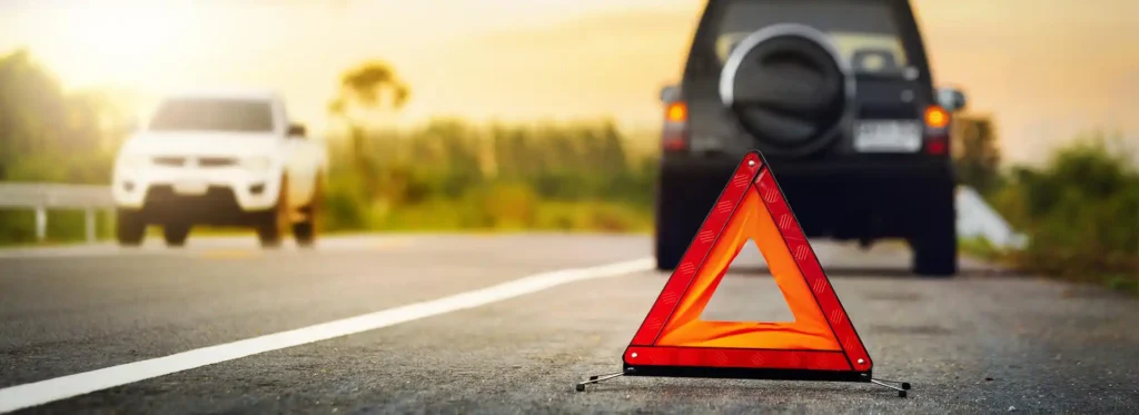 safety triangle on the road behind broken down vehicle