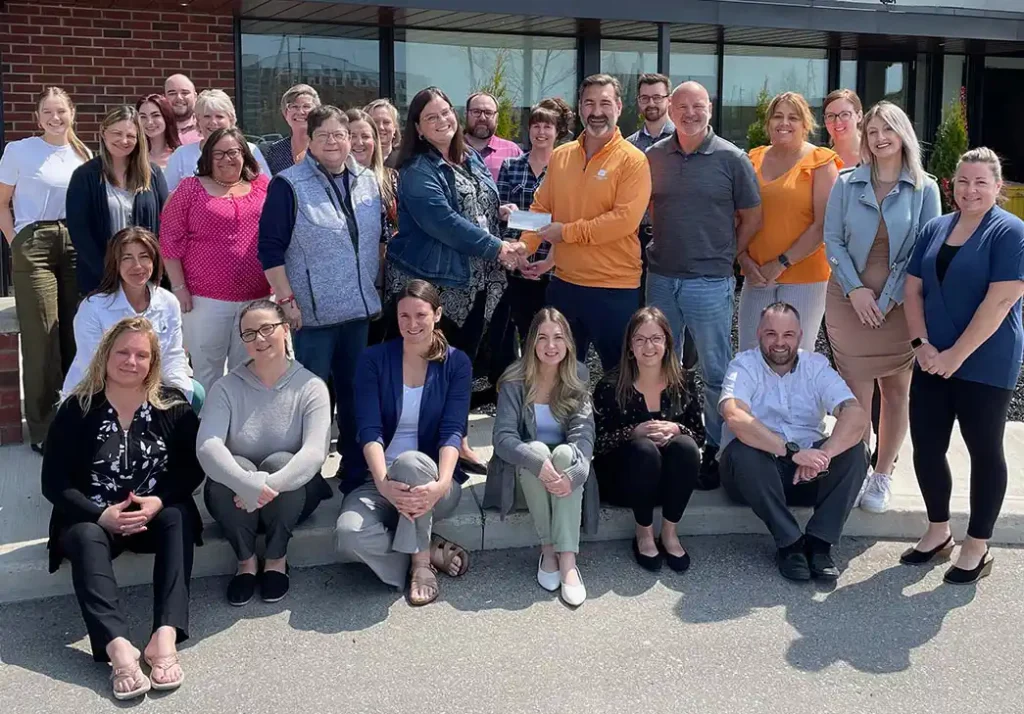 McLean & Dickey staff presenting Definity grant cheque to the Lighthouse