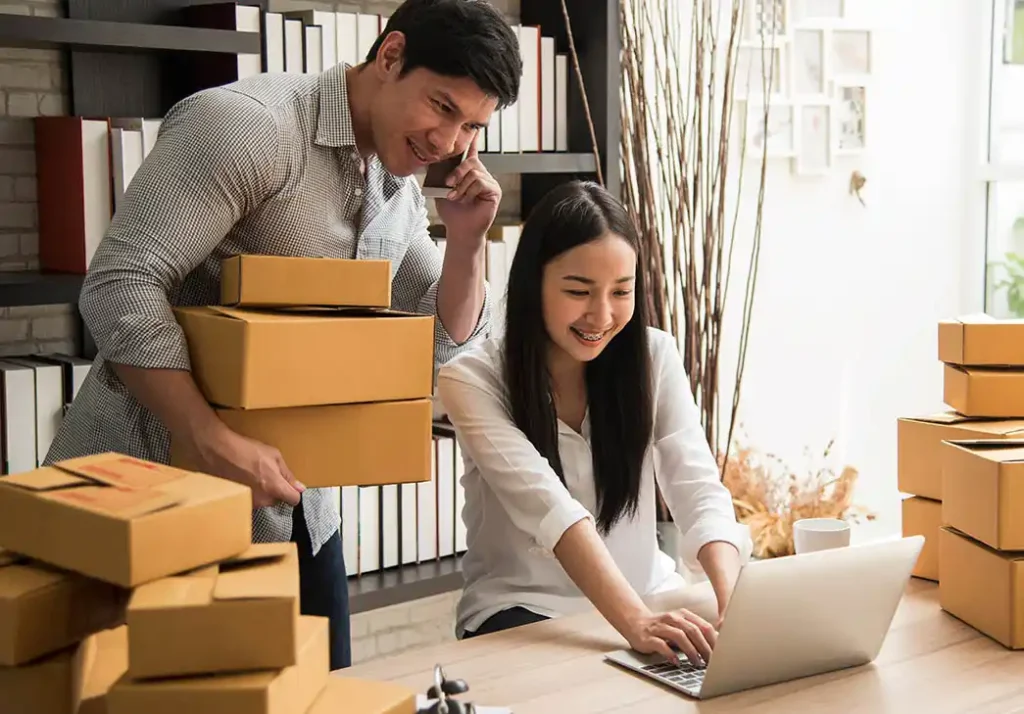 Couple running a home-based business taking an order over the phone