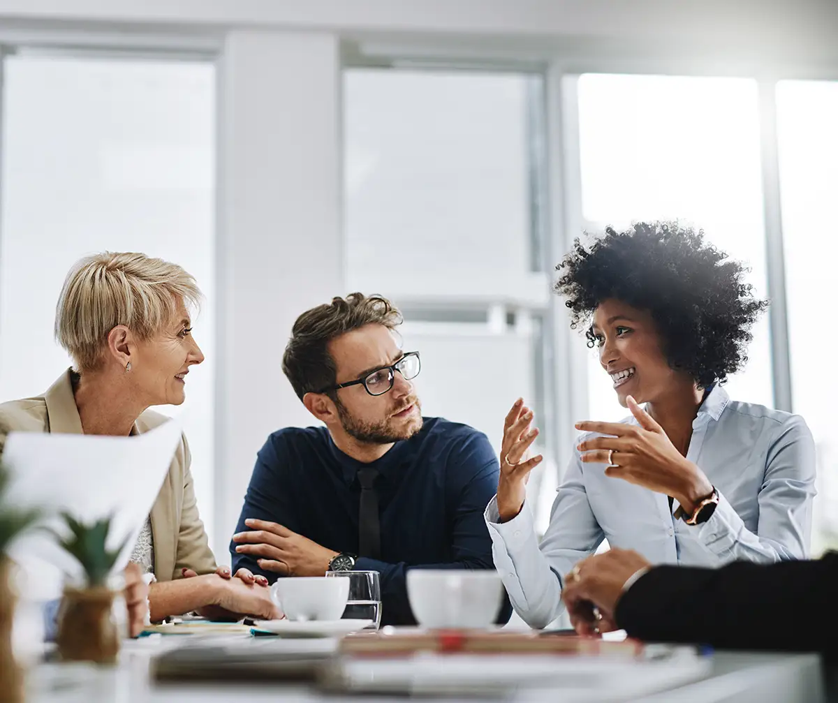 Shot of a group of businesspeople sitting together in a meeting.