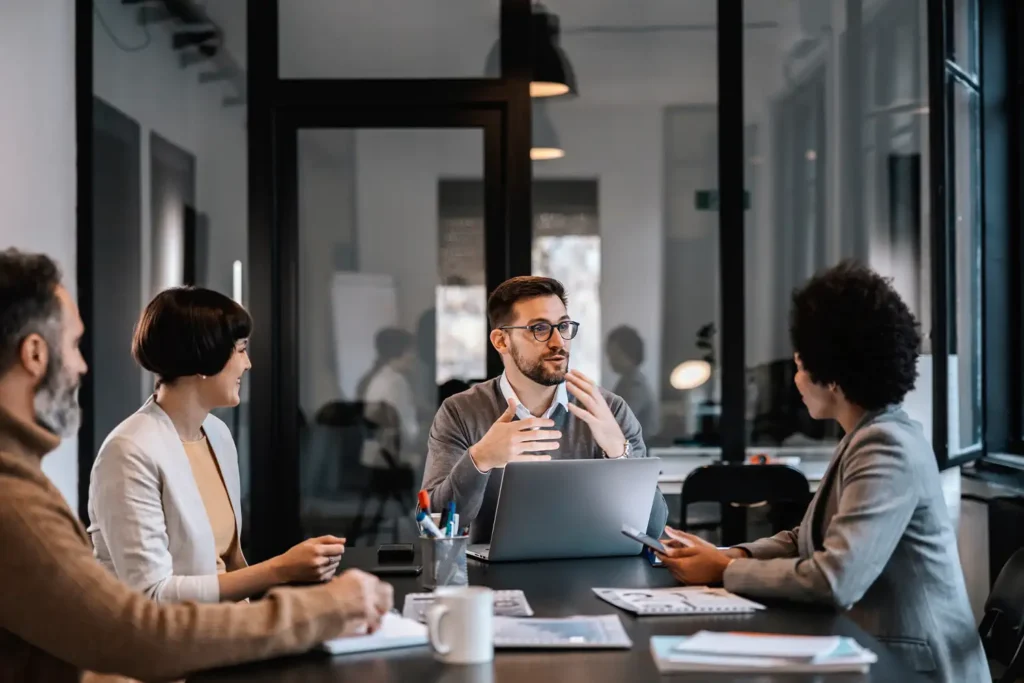 A business man is explaining the importance of project while sitting at the boardroom in corporate firm.